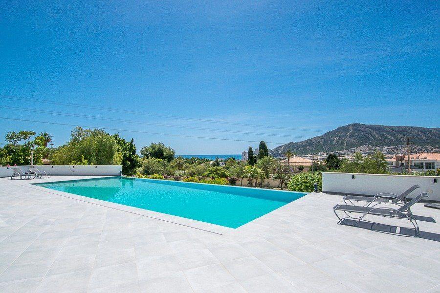913DA - Villa moderne entièrement rénovée avec vue panoramique sur la mer, piscine à débordement et court de tennis.
